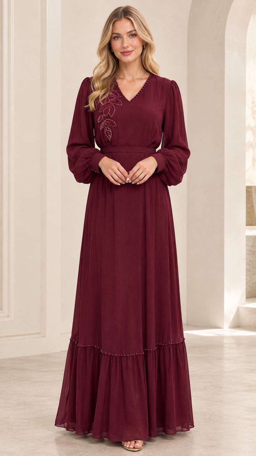 Front full view of woman wearing burgundy long sleeve beaded maxi dress with belt