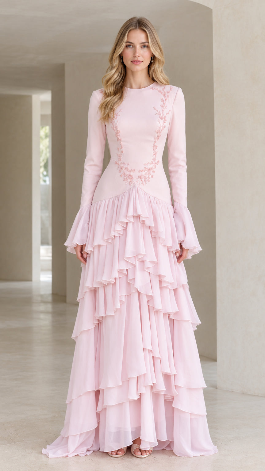 Front full-length view of woman in blush pink embroidered long sleeve tiered ruffle maxi gown