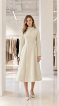 Cream stand-collar A-line midi dress coat front view on model