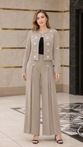 Front view of model wearing taupe embellished cropped jacket and wide-leg pant suit set
