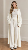 Front full view of woman wearing cream 3-piece knit lounge set with maxi cardigan and wide-leg pants