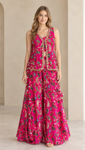 Full front view of model wearing magenta paisley 3-piece palazzo pant set with embellished sleeveless jacket
