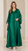 Front view of model wearing an emerald green satin embroidered kaftan maxi dress