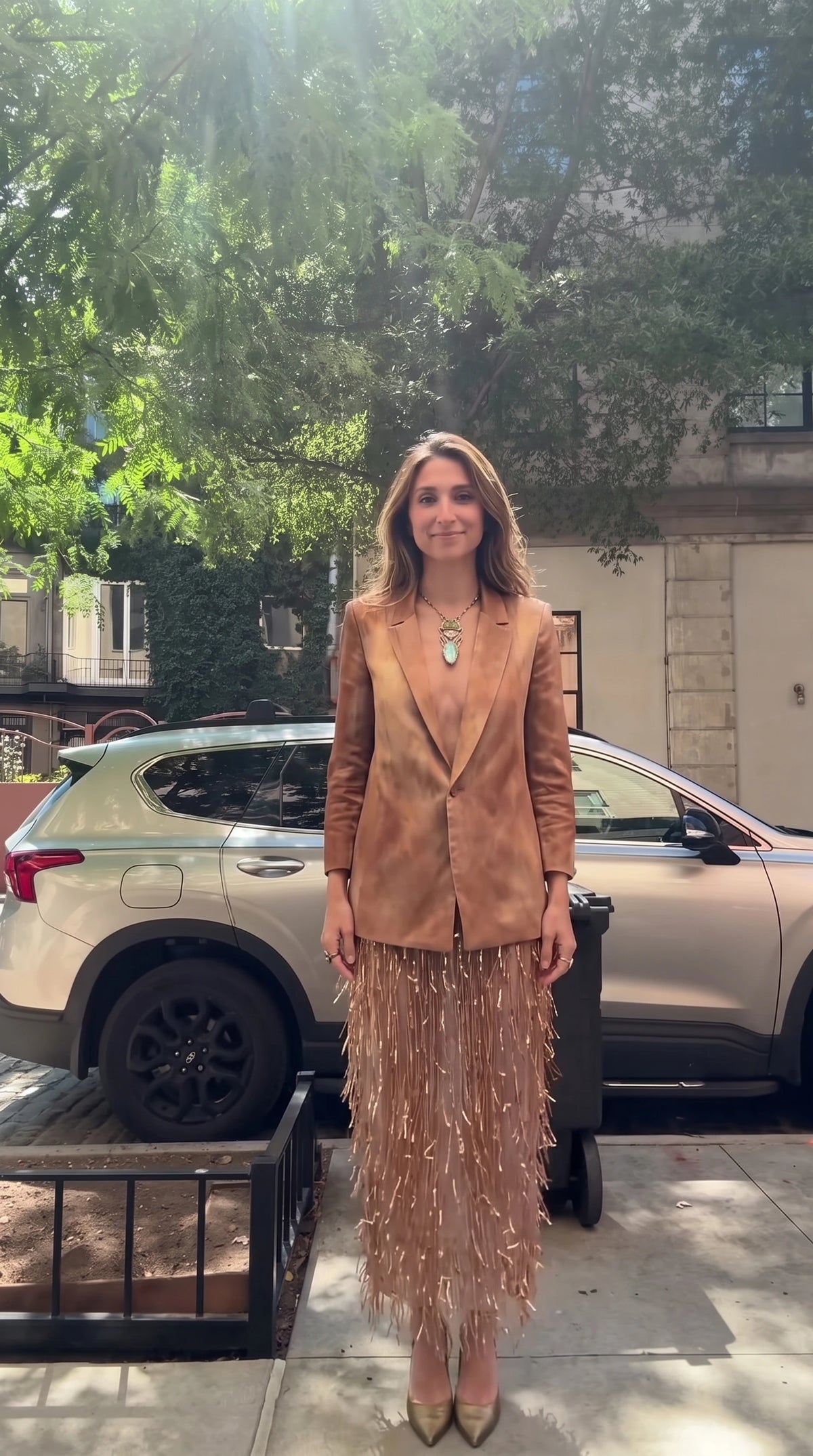 Front full view of model wearing tan tie-dye blazer and matching fringe midi skirt set
