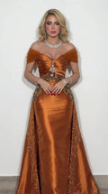 Front view of model wearing rust orange off-the-shoulder satin evening gown with beaded waist