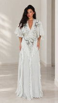 Front view of woman wearing elegant ice blue embroidered flutter sleeve maxi dress