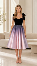 Front view of a black and lavender vintage midi dress with bow shoulder straps