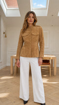 Front view of model wearing camel faux suede stand collar tailored jacket with white wide leg pants