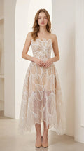 Front view of woman wearing strapless champagne beaded leaf embroidered midi dress