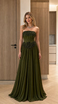 Front view of model wearing olive green strapless beaded corset pleated maxi gown