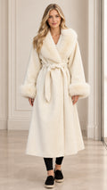 Full front view of women's ivory belted long wrap coat with faux fur collar and cuffs