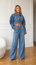 Front view of model wearing denim blue crocodile embossed cropped jacket and wide leg pants set