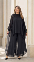 Model wearing black sequin chiffon top and wide leg pants set, front view