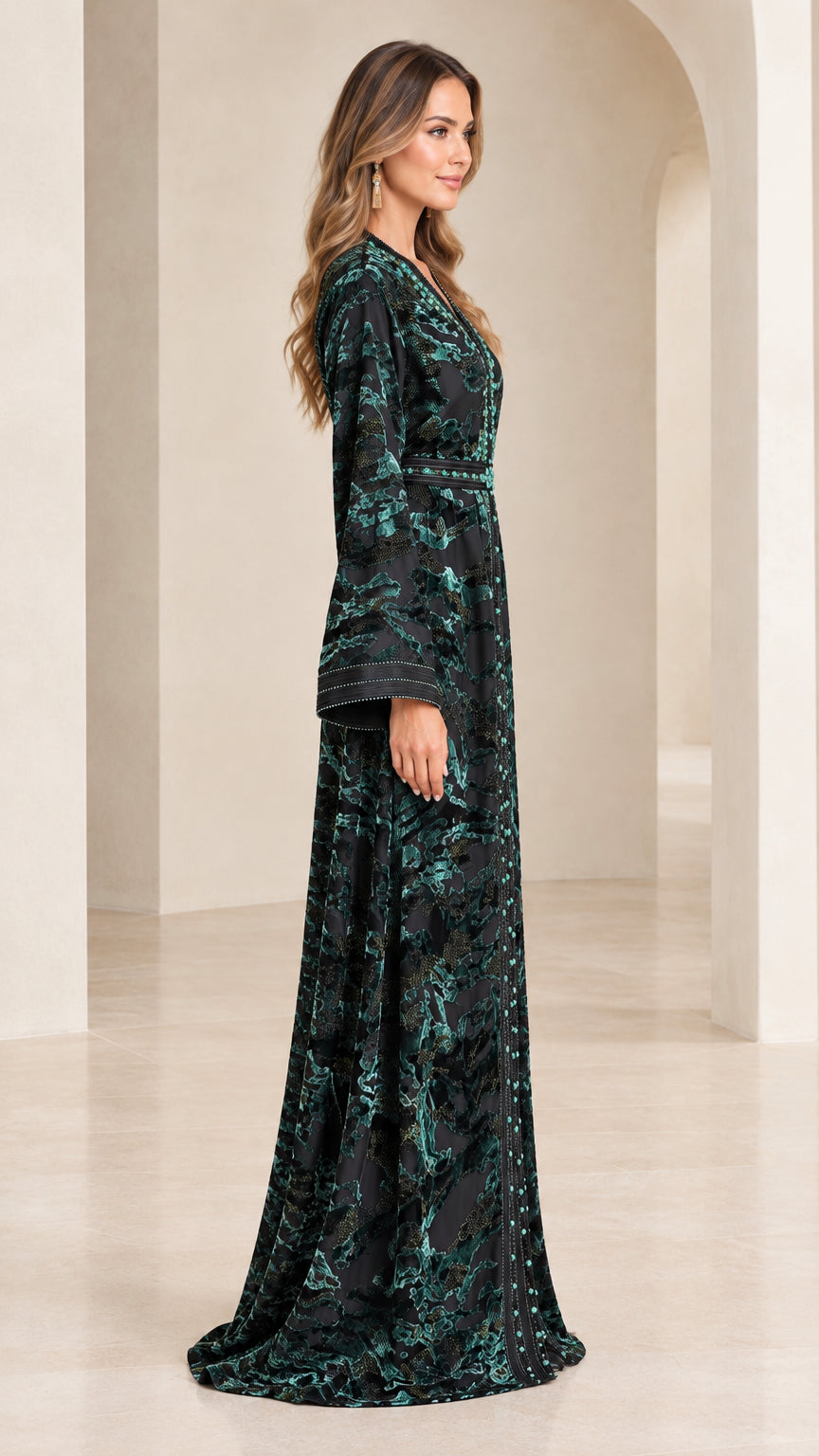 Side profile of woman in emerald green long sleeve velvet formal kaftan gown