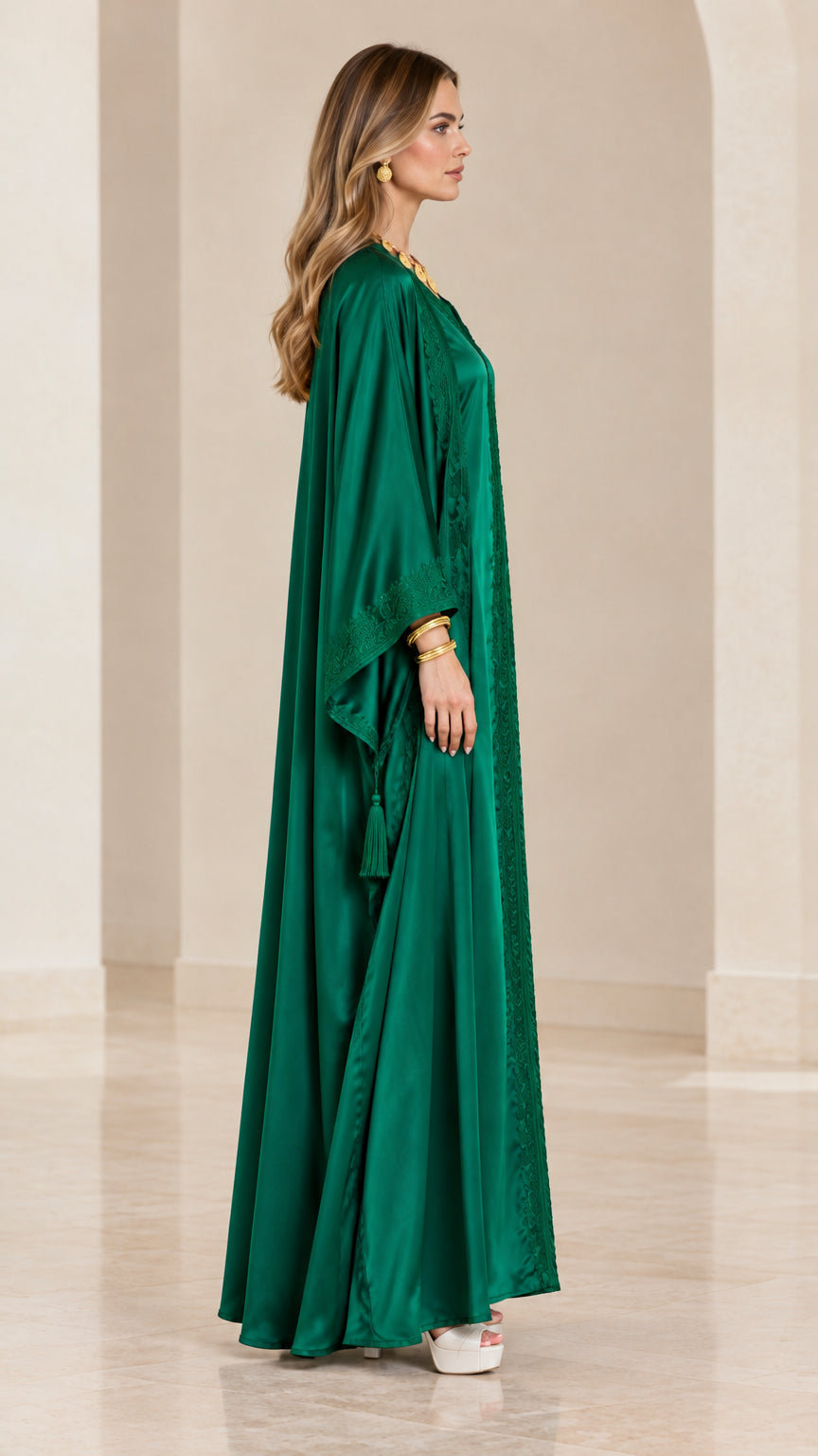 Side profile view of emerald green satin kaftan dress showing flowing silhouette