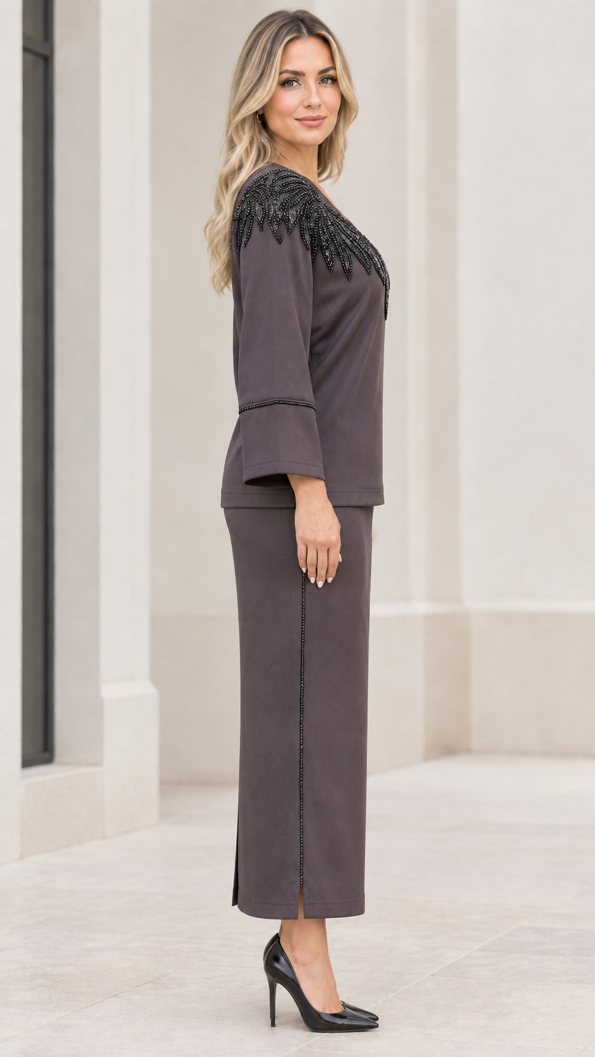 Side profile view of women's charcoal grey formal two-piece maxi skirt set