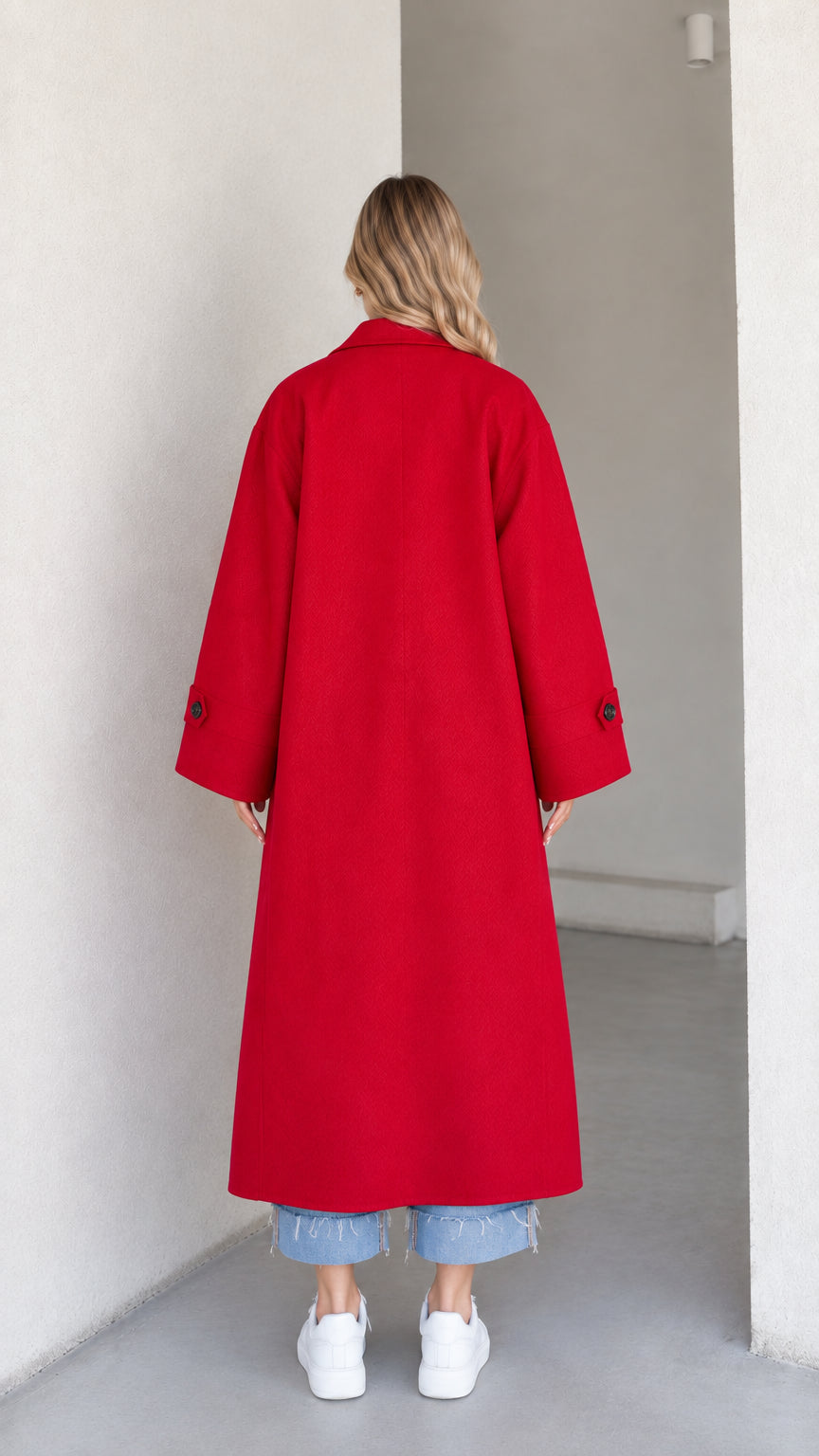 Back view of model wearing a full-length red overcoat