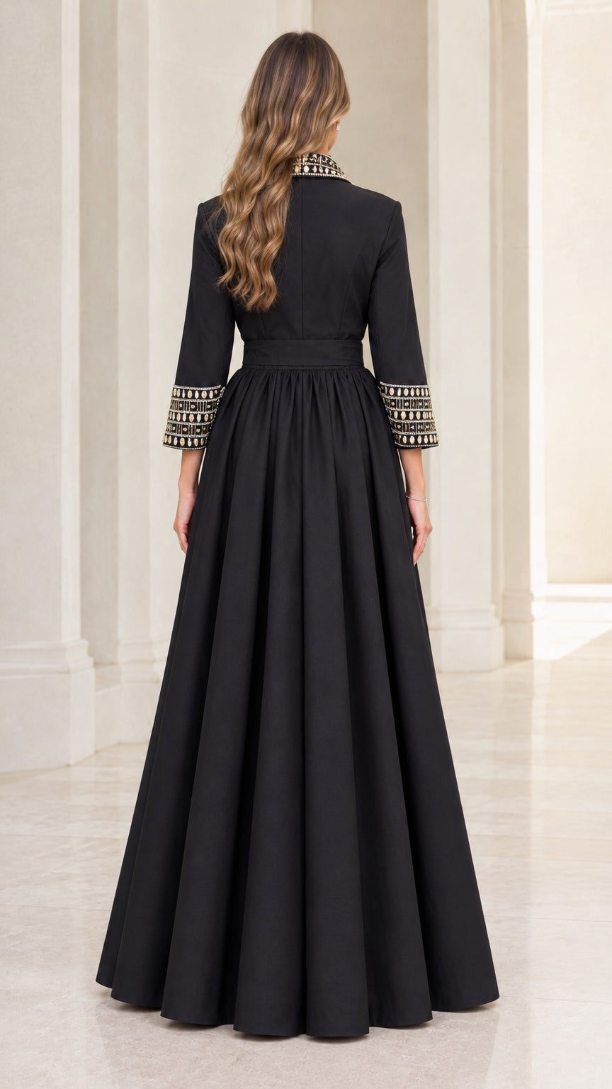 Back full-length view of model wearing black 3/4 sleeve pleated evening gown