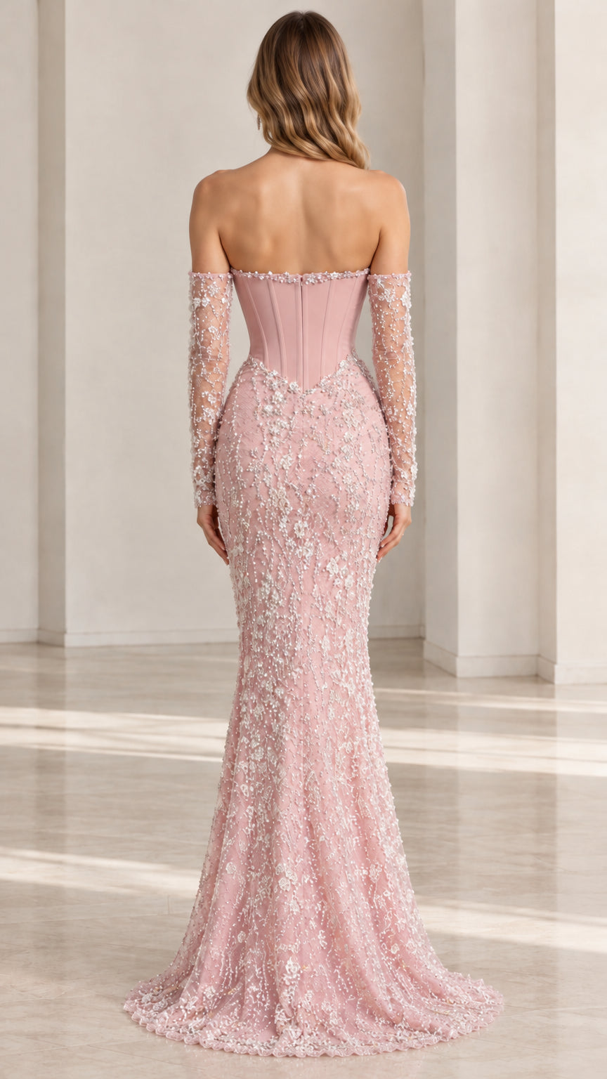 Back view of woman wearing Dusty Pink strapless mermaid dress with sweep train