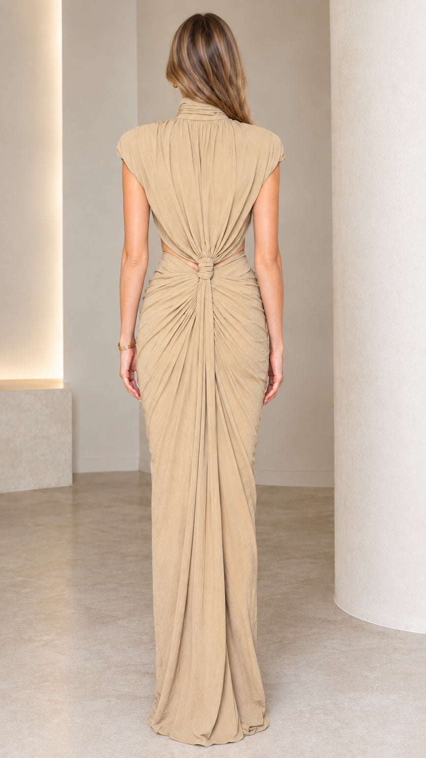 Back view of beige cutout draped maxi dress showing knot detail and open waist back