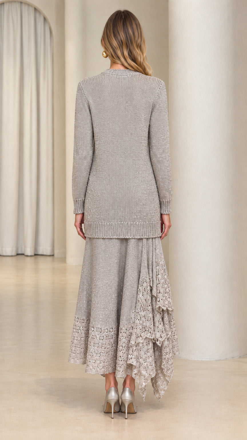 Back view of model wearing silver grey longline knit sweater and matching midi skirt