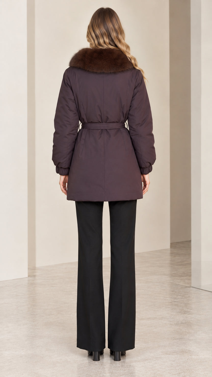 Back view of deep plum belted parka jacket showing length and silhouette