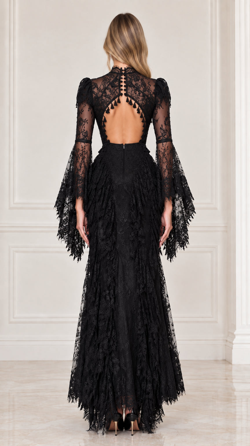 Back view of black lace evening gown highlighting open keyhole back and tassel accents