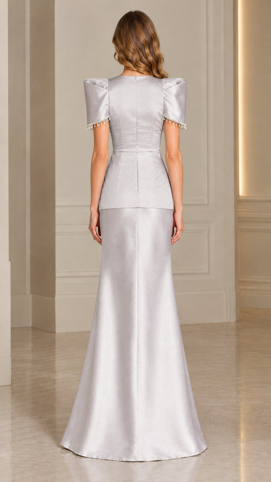 Back view of silver satin gown highlighting waist tie and clean floor-length drape