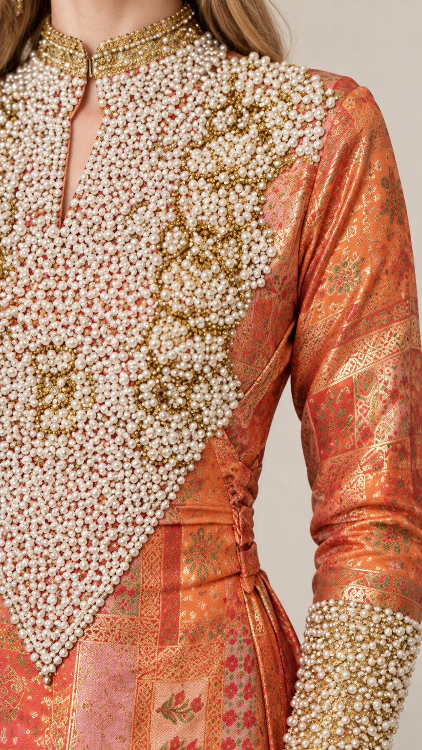 Close-up detail of faux-pearl and beaded embroidery on yoke and cuff