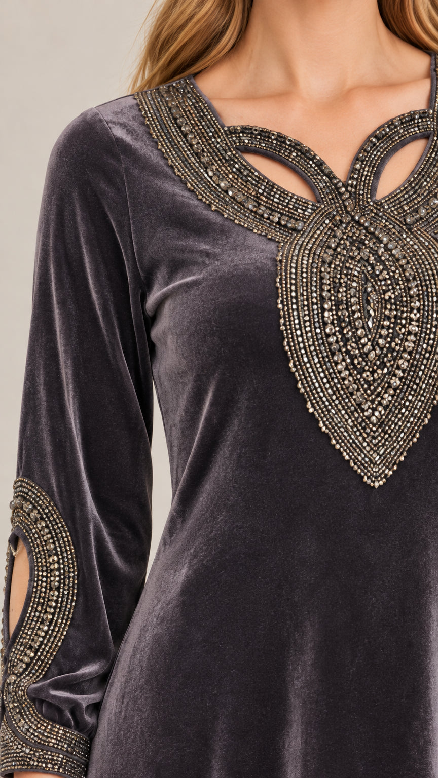 Close up of beaded and stud cutout neckline and sleeve detail on velvet fabric