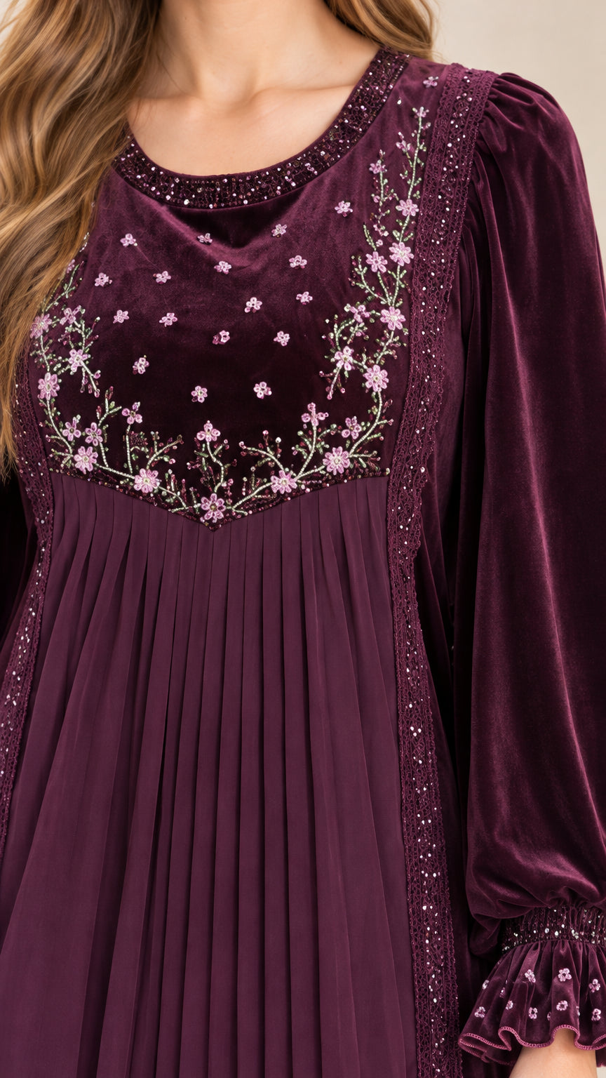 Close-up detail of floral embroidery, beading, and pleated panel on bodice