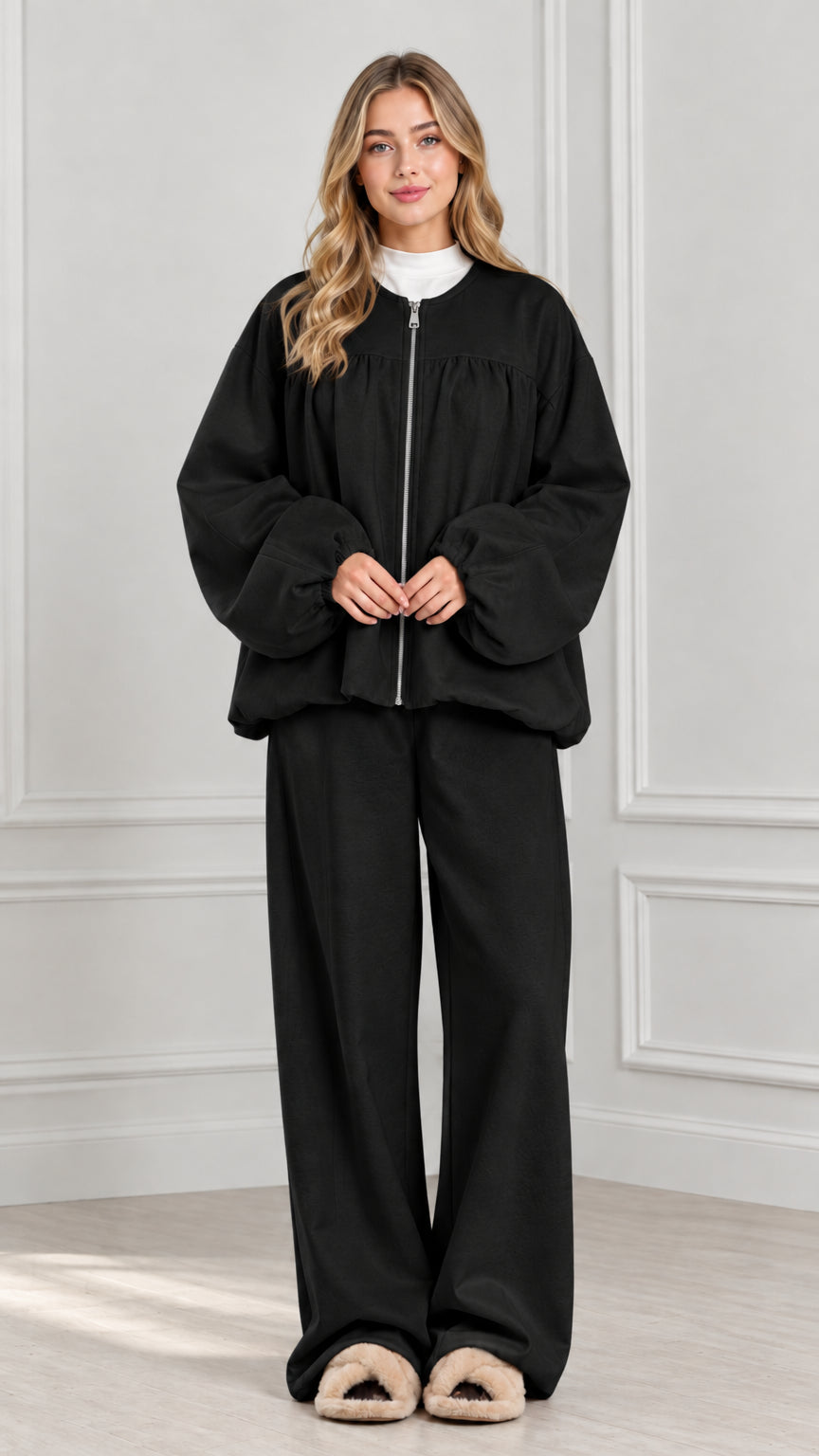 Full-body view of black two-piece zip jacket and wide-leg lounge set
