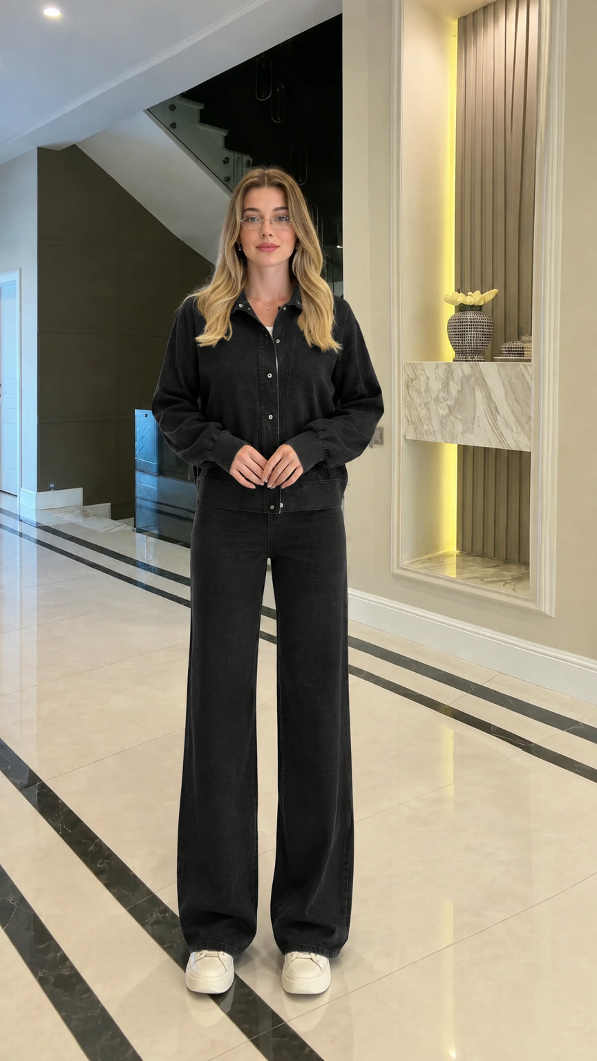 Full body studio shot of woman in black collared zip-up two-piece casual set