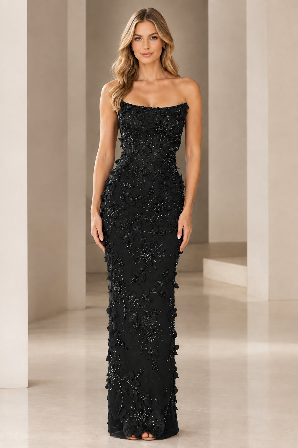 Front view of strapless 3D floral beaded column gown in black